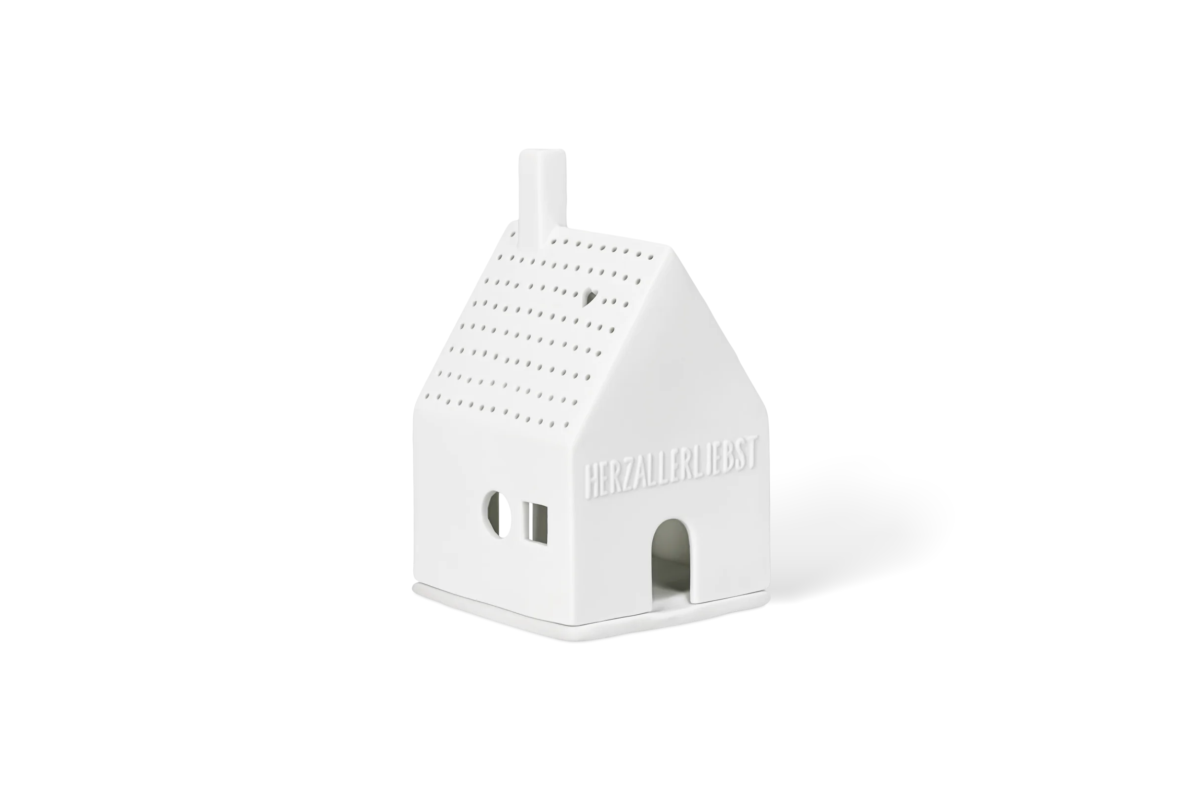 Lichthaus Herzallerliebst Weißes Lichthaus mit erhabenem Schriftzug Herzallerliebst Herzfenster und punktiertem Dach in der vorderen Linksansicht.