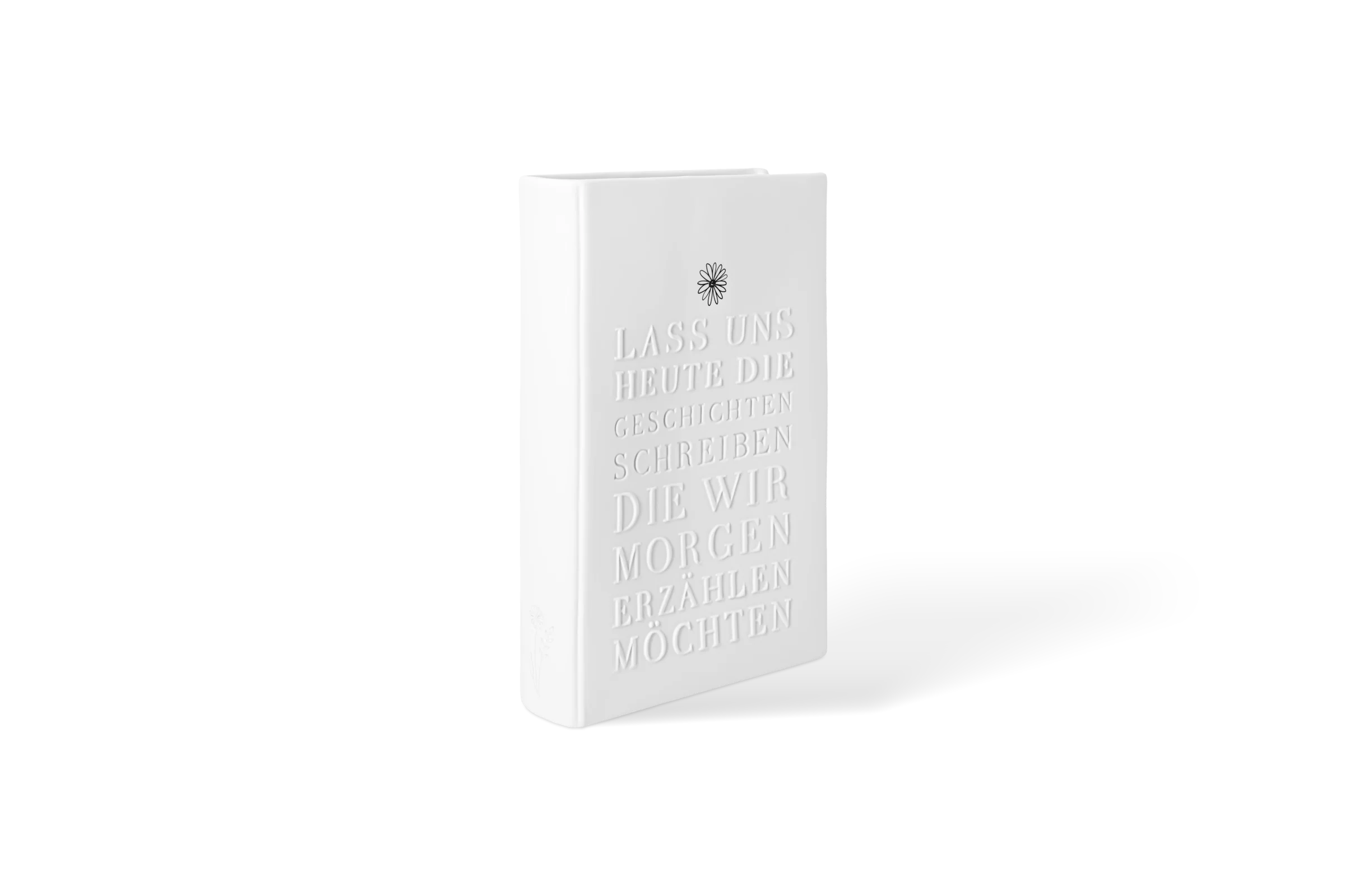 Weiße Vase Leseglück in Buchform mit erhabenem Schriftzug und Blumenmotiv in der vorderen Linksansicht.