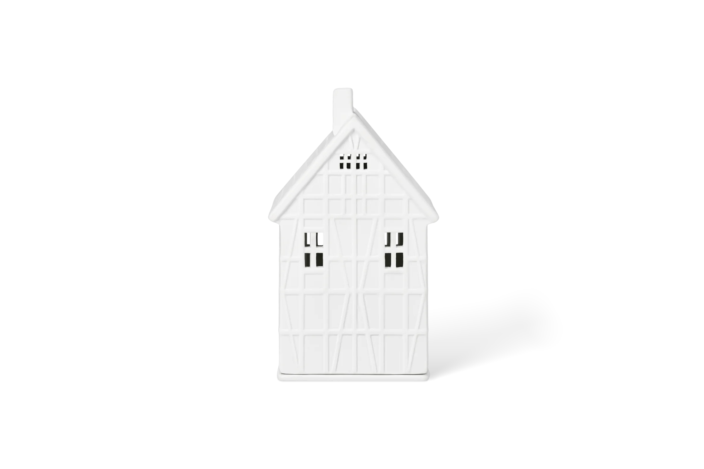 Weißes Lichthaus aus Porzellan mit erhabenem Fachwerk, Schornstein und Fenstern in der Rückansicht.