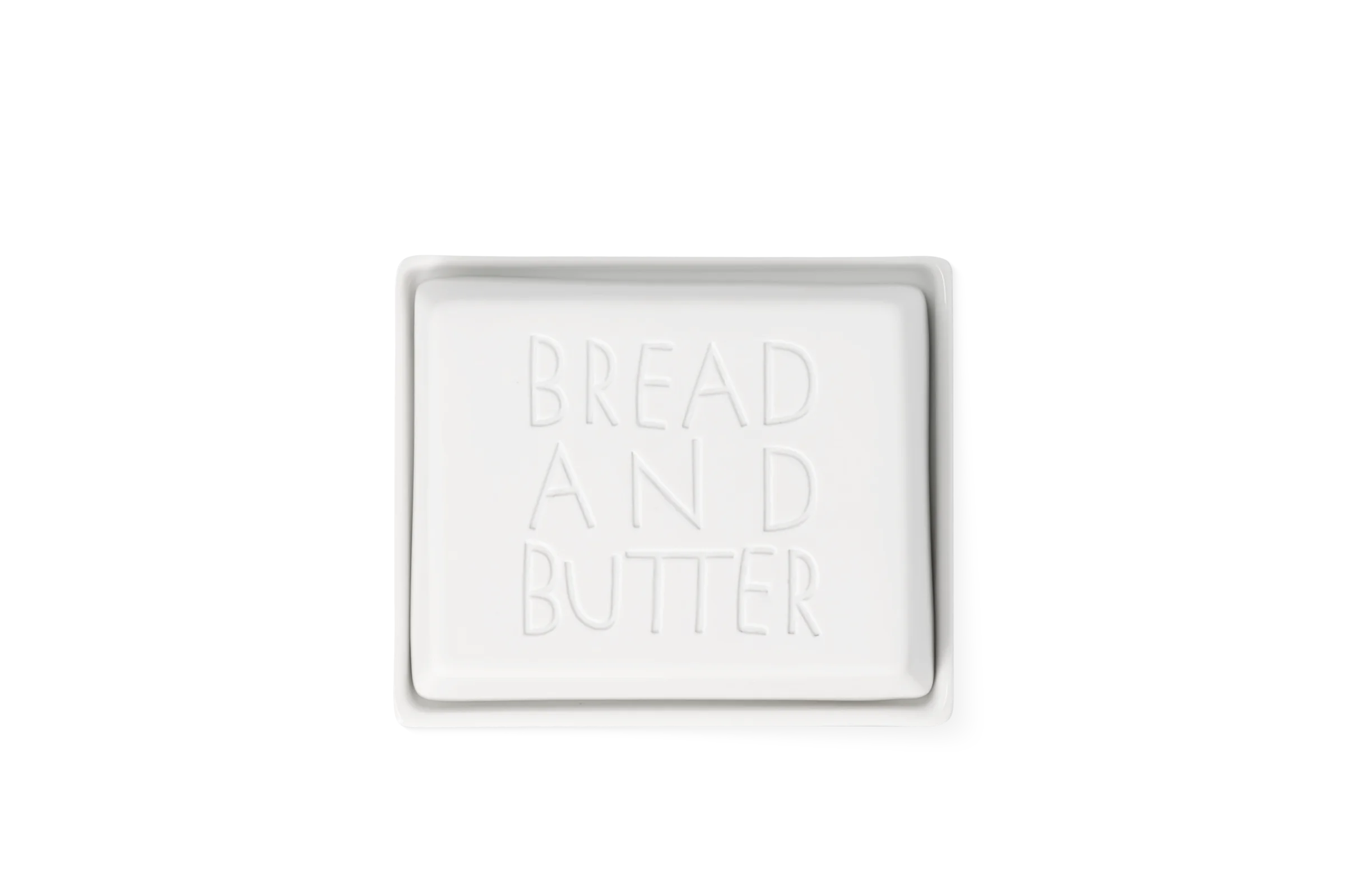 Butterdose Bread and Butter Klein Weiße rechteckige Butterdose mit abgerundeten Ecken und tiefgeprägtem Schriftzug Bread and Butter in der Draufsicht.