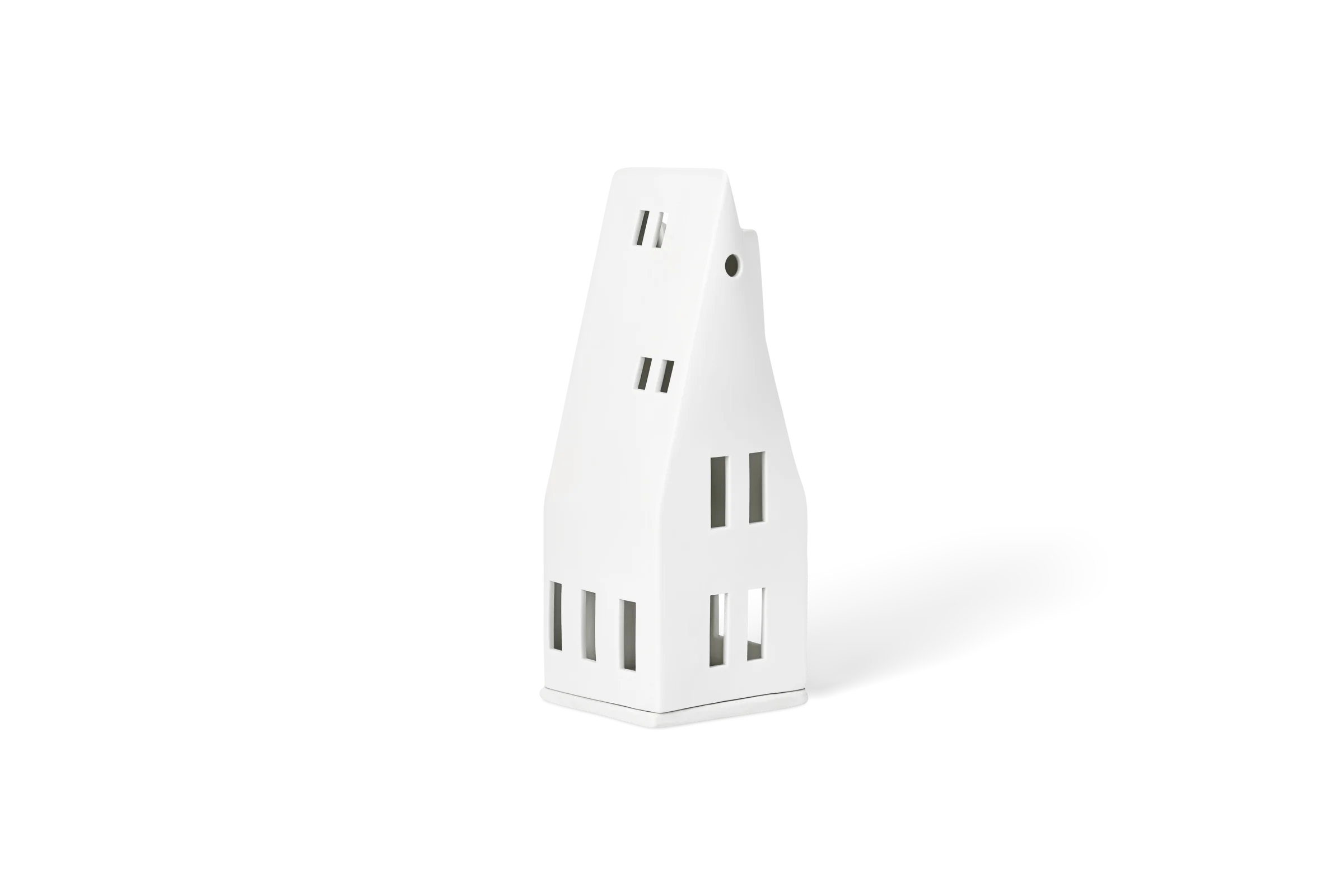 Lichthaus Spitzdach Weißes Lichthaus aus Porzellan mit ausgeschnittenen Fenstern und schmalem Schornstein in der vorderen Linksansicht.