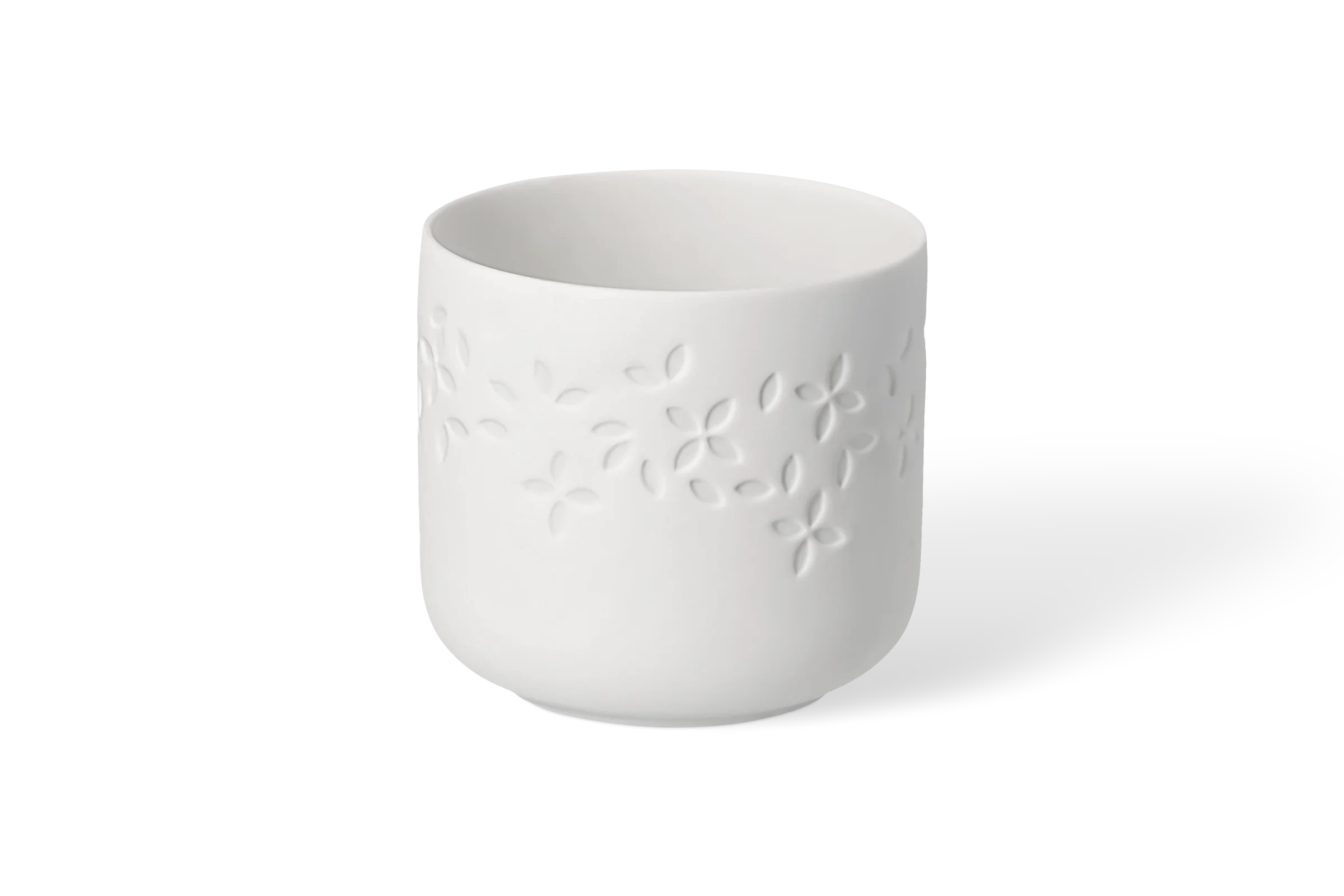 Teelichthalter Cozy Time Blütenblätter Weißer Teelichthalter aus Porzellan der Serie Cozy Time mit tiefgeprägten Blüten in der Vorderansicht.