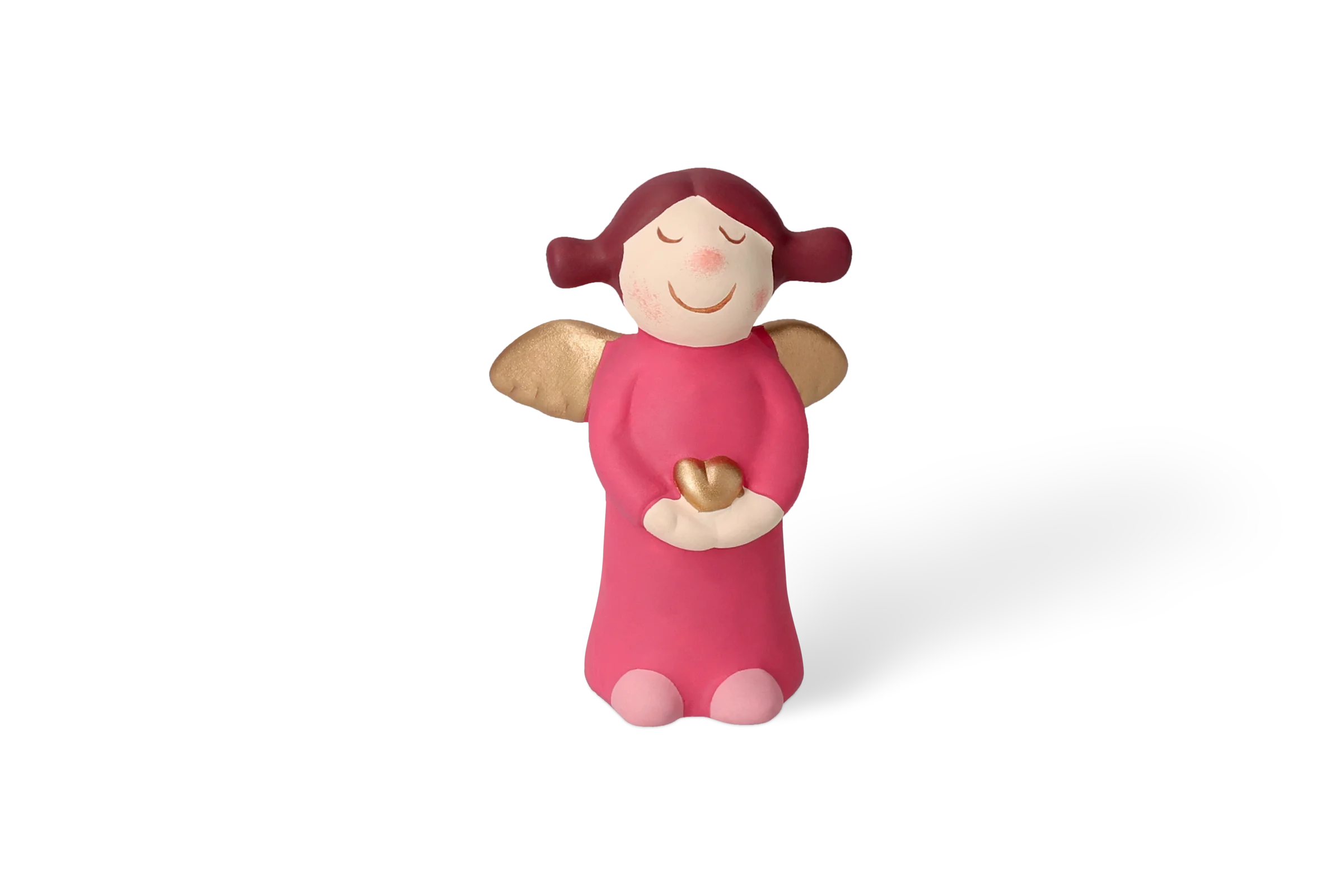 Engel Charlotte Klein - Edition 9 Dekofigur Himmlische Schwester mit goldenen Flügeln, die ein pinkes Kleid trägt und ein kleines goldenes Herz hält, in der Vorderansicht.