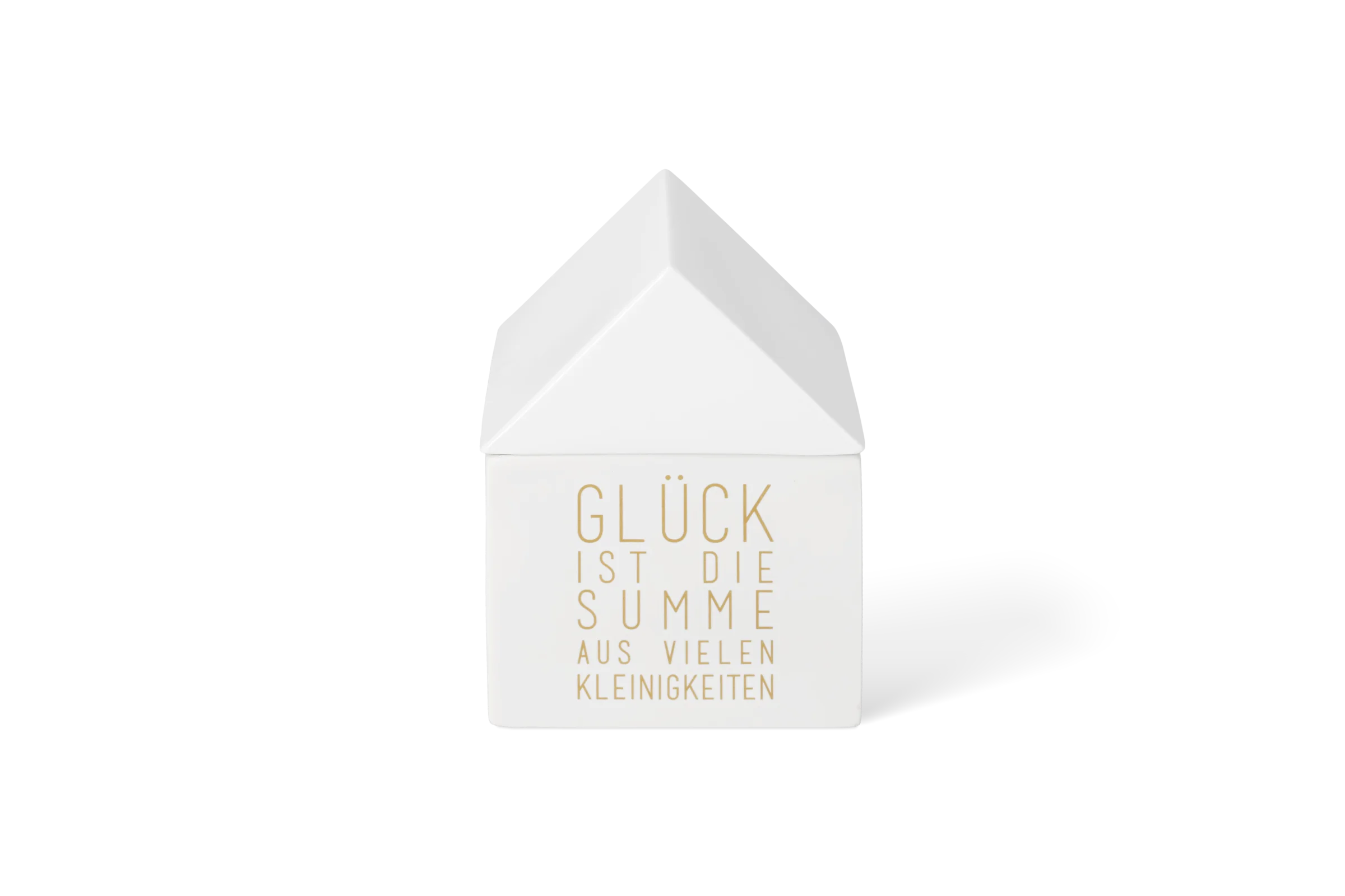 Weiße Dose in Hausform mit goldenem Schriftzug Glück ist die Summe aus vielen Kleinigkeiten, in der Vorderansicht.